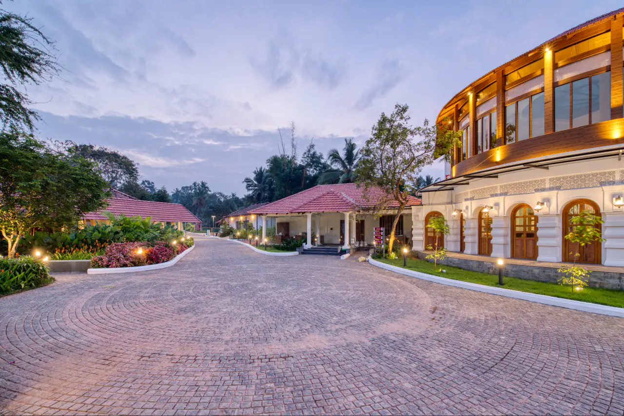 Paved arrival court at the Kerala Arts and Crafts Village at dusk